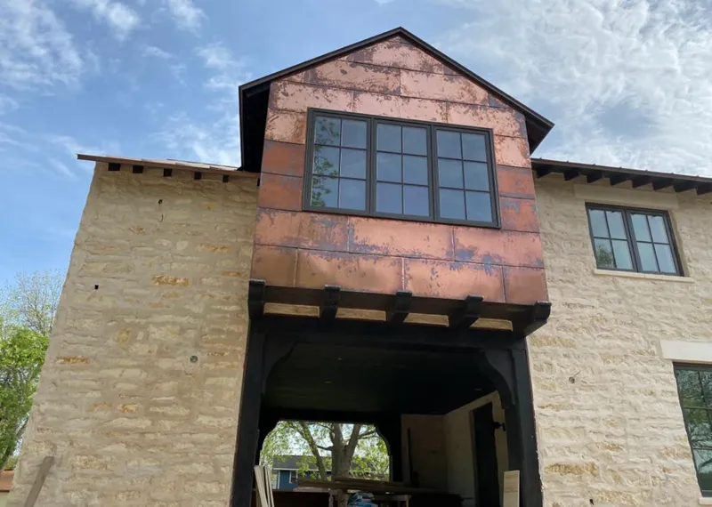 Copper metal panel facade on a stone building for Metal Roof Coating in Baytown