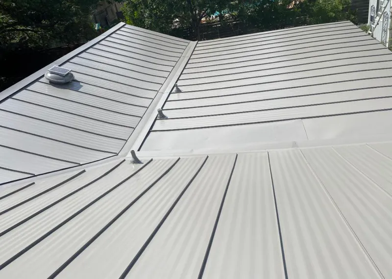Solar attic fan installed on a metal roof for Roof Ventilation in Baytown